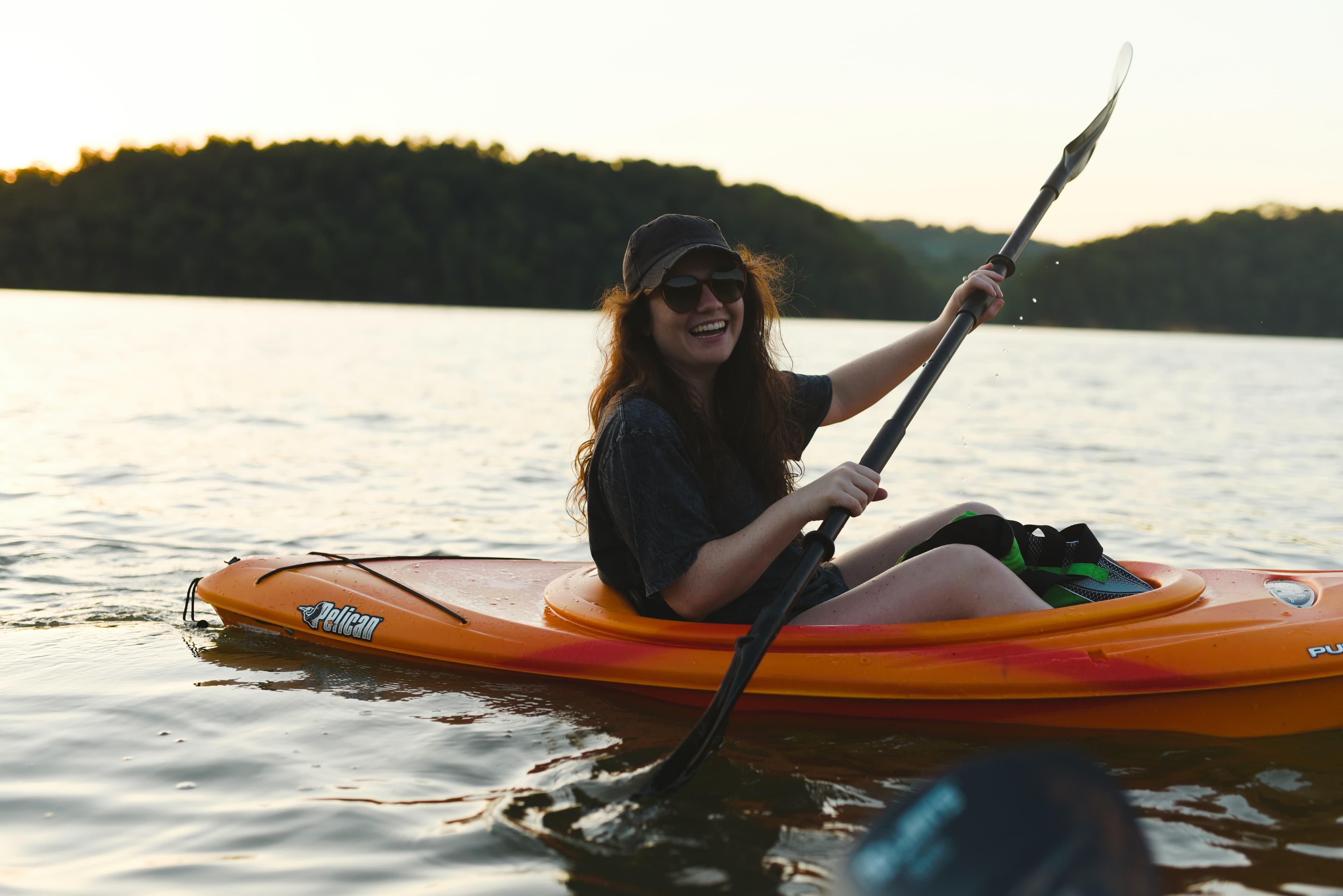 Woman kayaking at golden hour — Forward Outdoor